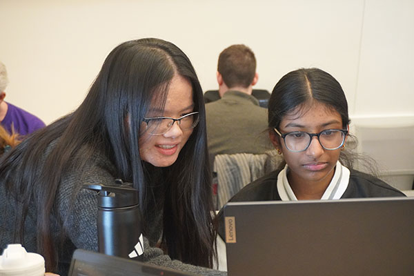 MIT student Arianna helping Technovation student