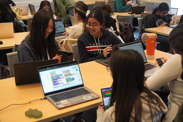 Technovation students smiling at their apps