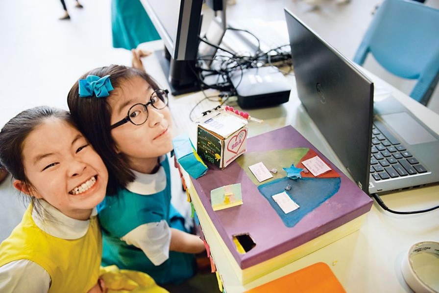 CoolThink Girls Smiling in front of a computer
